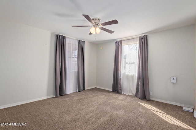 carpeted empty room featuring ceiling fan