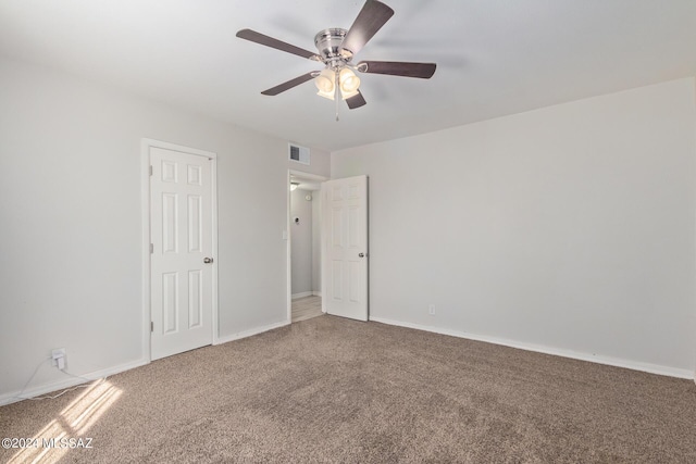 empty room with carpet flooring and ceiling fan