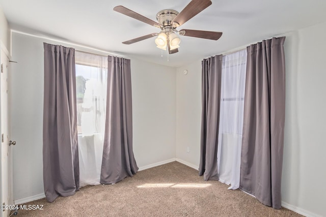 unfurnished room with carpet flooring and ceiling fan