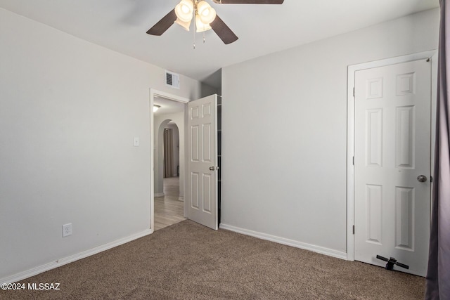 unfurnished bedroom featuring ceiling fan and carpet floors