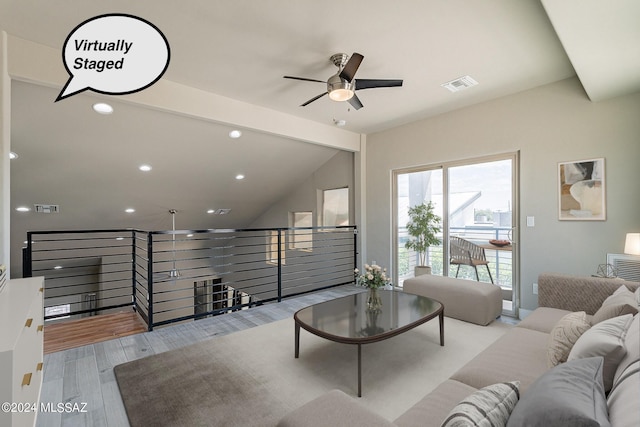 living room featuring vaulted ceiling with beams, light hardwood / wood-style floors, and ceiling fan