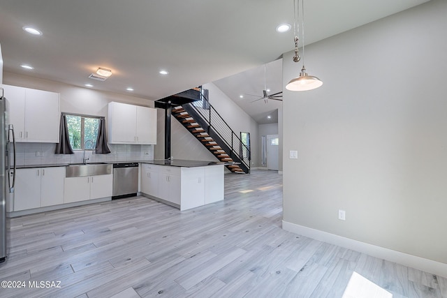 kitchen featuring white cabinets, sink, stainless steel appliances, and light hardwood / wood-style flooring