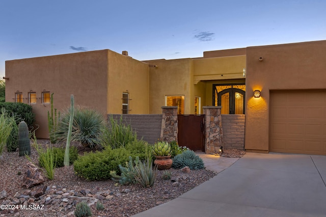 southwest-style home with a garage