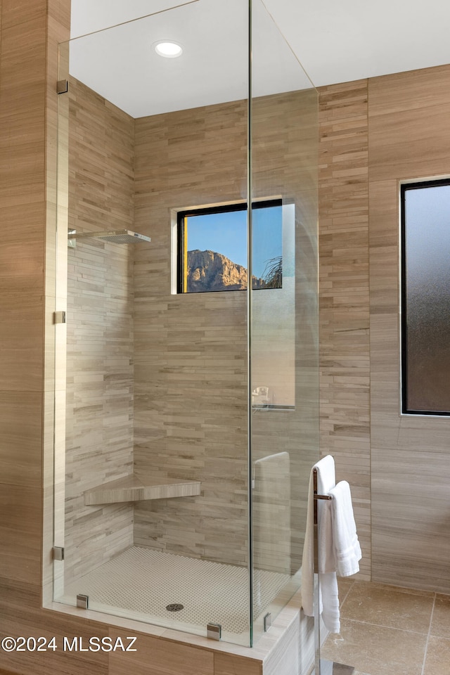 bathroom featuring a shower with door