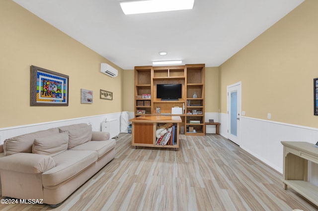 living room featuring a wall unit AC and light wood-type flooring