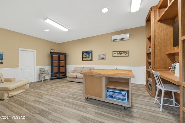 office with an AC wall unit and light hardwood / wood-style floors