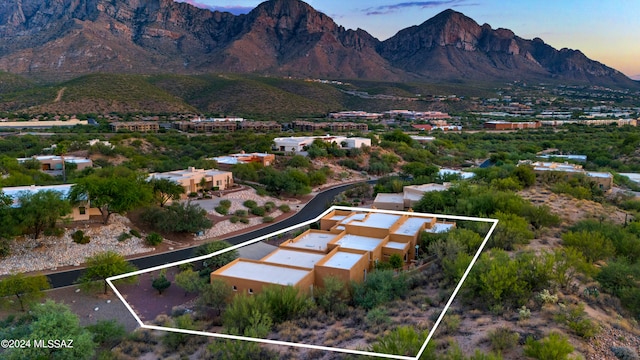 aerial view at dusk featuring a mountain view