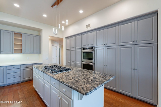 kitchen featuring gray cabinetry, visible vents, stainless steel appliances, and a kitchen island