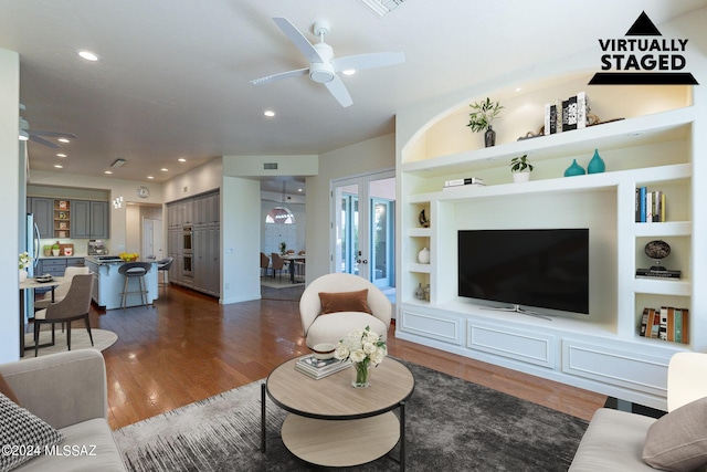 living area featuring recessed lighting, a ceiling fan, dark wood-type flooring, built in features, and french doors