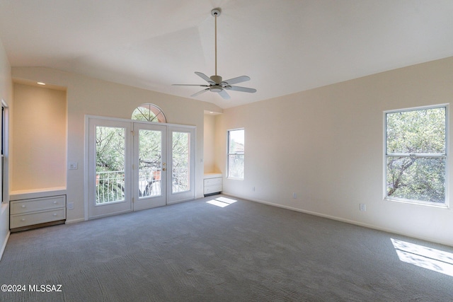 spare room with carpet flooring, ceiling fan, vaulted ceiling, and french doors