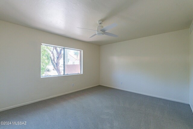 carpeted spare room featuring ceiling fan