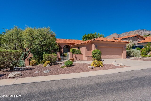 view of front of property with a mountain view and a garage