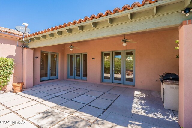 back of property featuring a patio, ceiling fan, and french doors