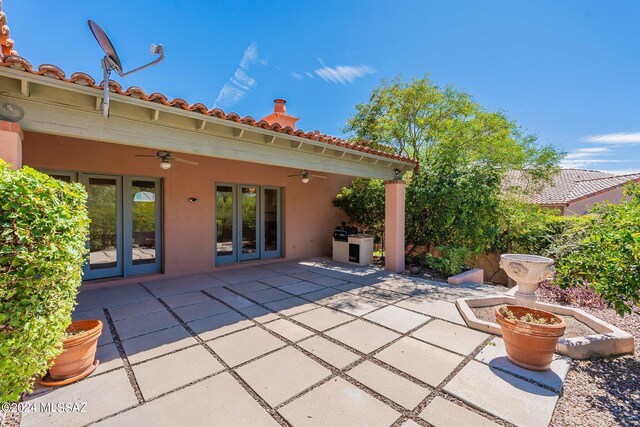 view of patio featuring ceiling fan and french doors