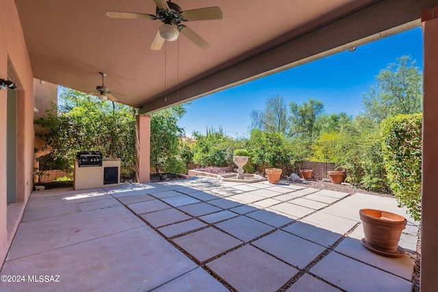 view of patio featuring fence and a ceiling fan
