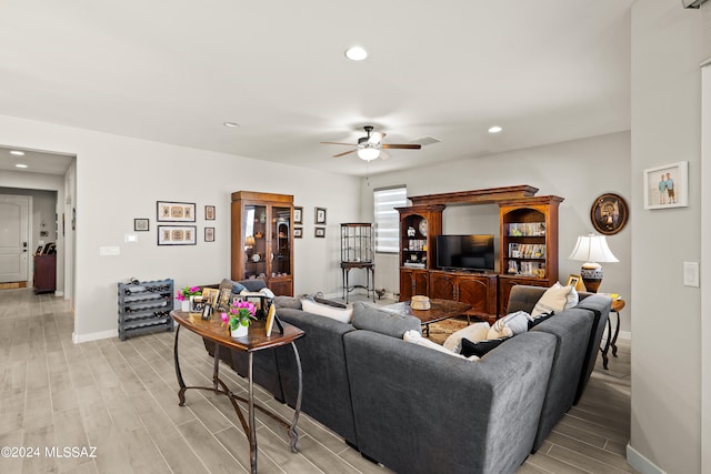 living room with ceiling fan and light hardwood / wood-style flooring