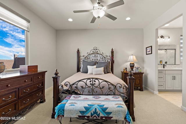 carpeted bedroom featuring ensuite bath and ceiling fan