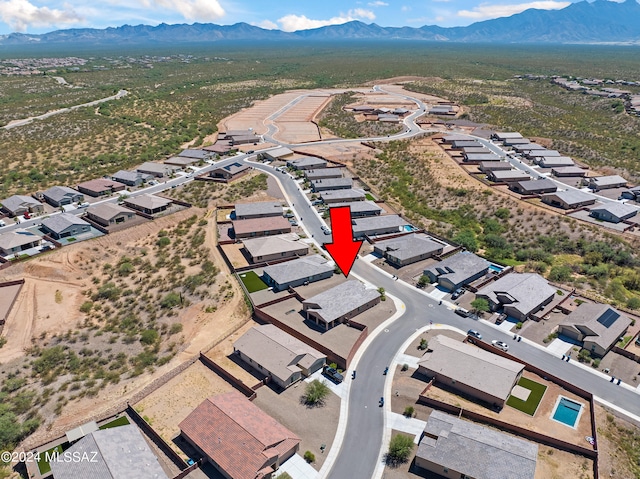 birds eye view of property with a mountain view