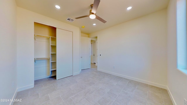 unfurnished bedroom with ceiling fan and a closet