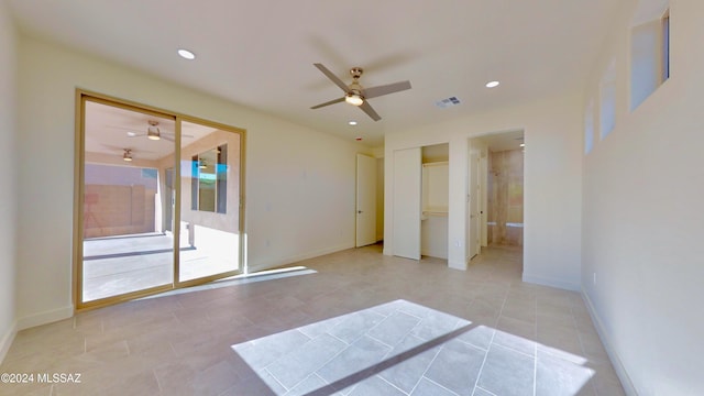 tiled empty room with ceiling fan