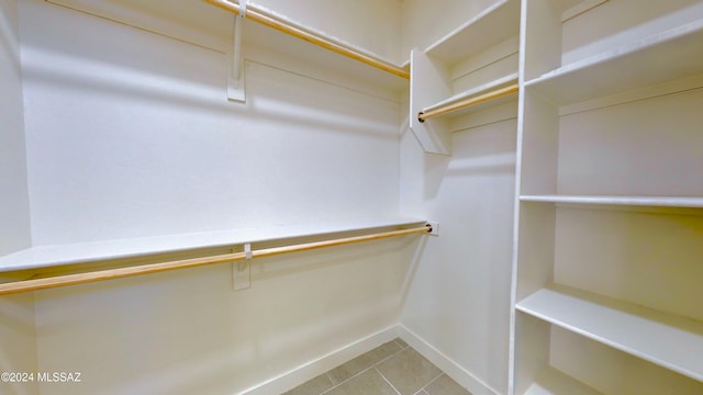 walk in closet with tile patterned floors