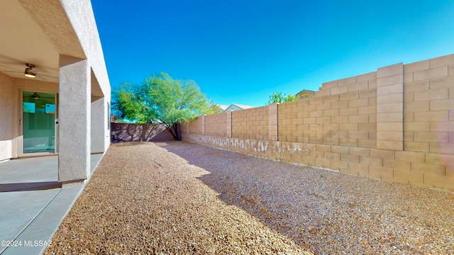 view of yard with a patio area and ceiling fan