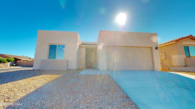 pueblo-style home with a garage