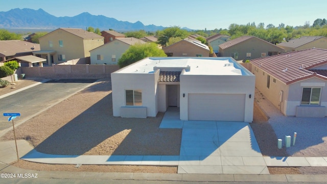 view of front facade featuring a mountain view and a garage