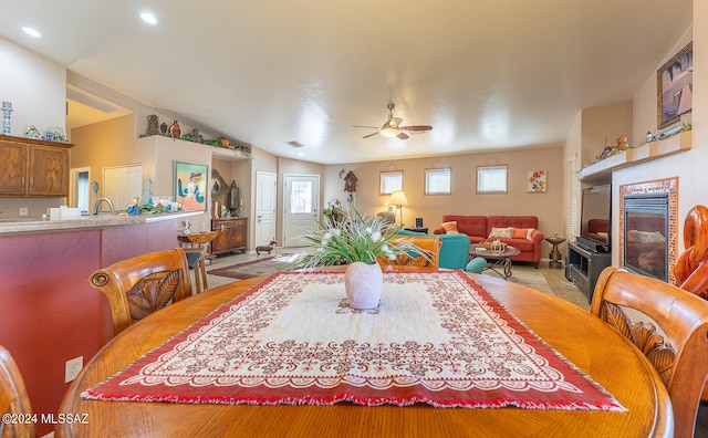 dining room with ceiling fan and vaulted ceiling