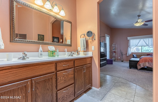 bathroom with tile patterned flooring, vanity, lofted ceiling, and ceiling fan