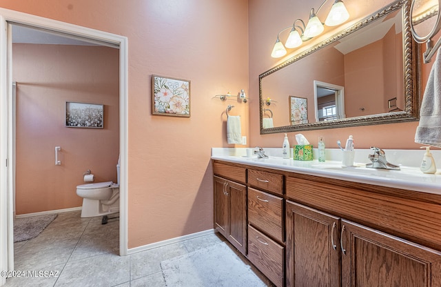 bathroom featuring vanity, toilet, and tile patterned floors