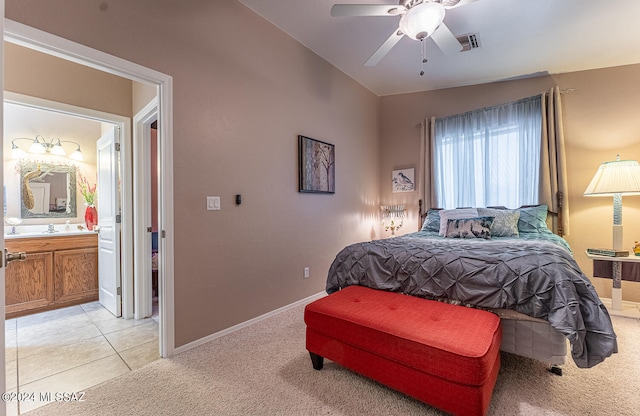 carpeted bedroom with lofted ceiling, ceiling fan, and ensuite bathroom