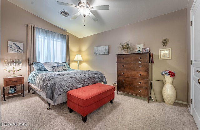 bedroom with ceiling fan, lofted ceiling, and light carpet