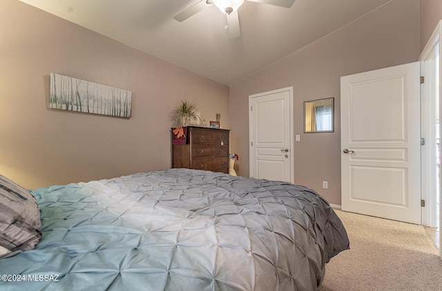 bedroom with ceiling fan, lofted ceiling, and light carpet