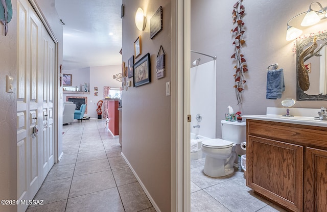 full bathroom featuring vanity, bathing tub / shower combination, toilet, and tile patterned floors