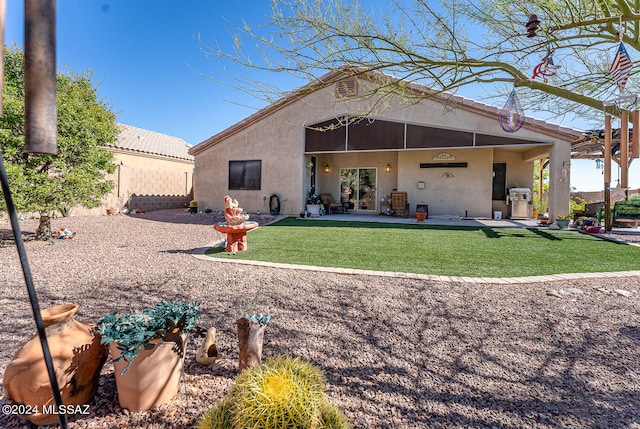 back of house with a lawn and a patio area