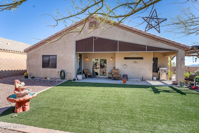 rear view of house with a patio and a yard