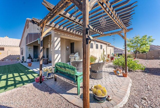 view of patio / terrace with a pergola and exterior kitchen