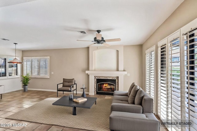 tiled living room with ceiling fan