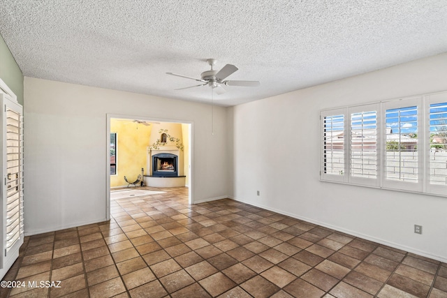 spare room featuring a textured ceiling and ceiling fan