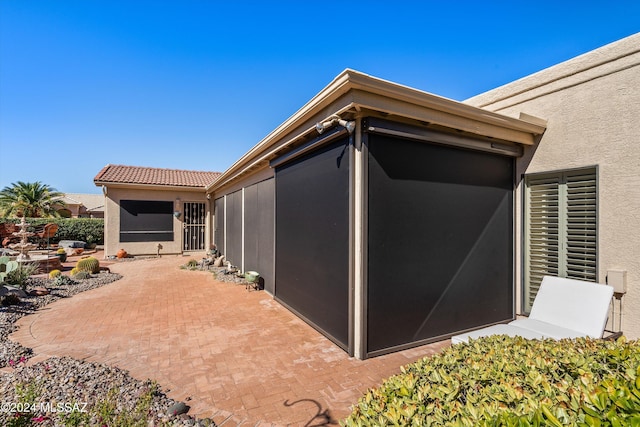 view of side of home featuring a patio