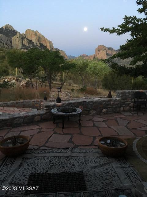 view of patio / terrace featuring a fire pit and a mountain view