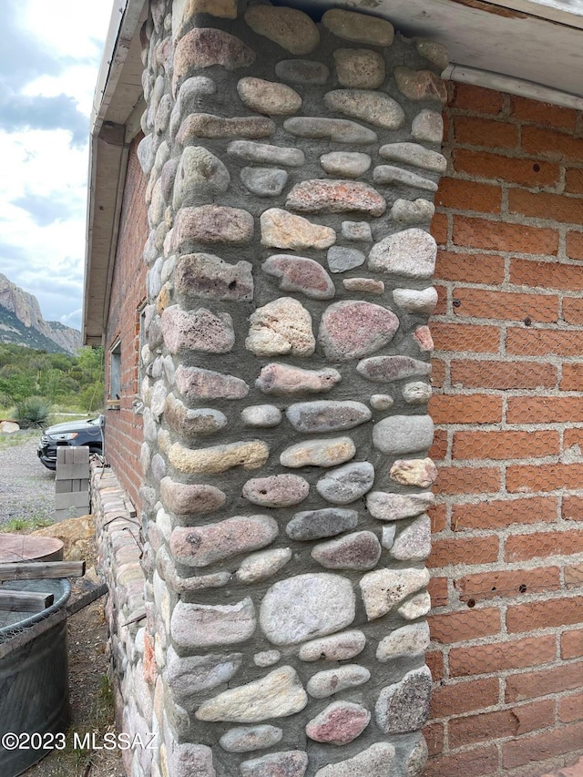 exterior details with a mountain view and brick siding