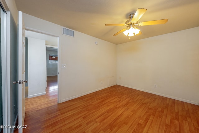 empty room featuring light wood-type flooring and ceiling fan