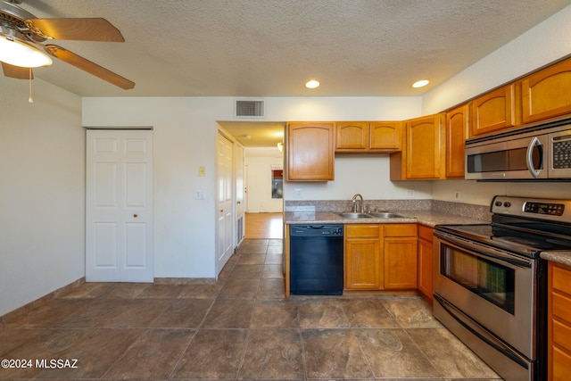 kitchen featuring a textured ceiling, ceiling fan, appliances with stainless steel finishes, and sink