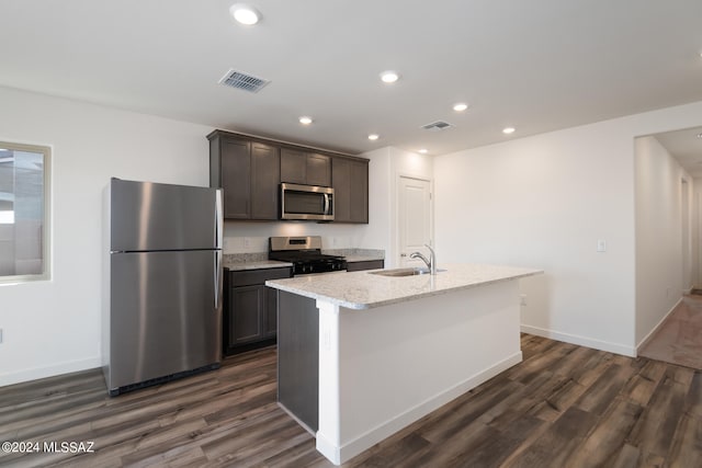 kitchen with dark wood finished floors, visible vents, stainless steel appliances, and a sink