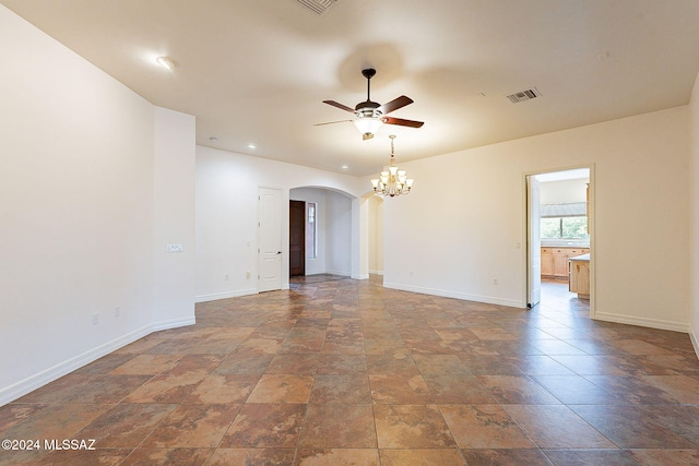 empty room with ceiling fan with notable chandelier