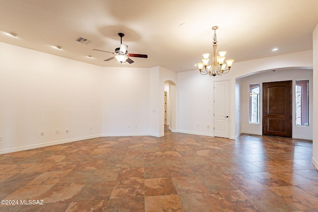 unfurnished room with ceiling fan with notable chandelier