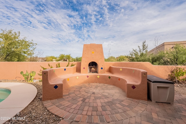 view of patio with an outdoor fireplace