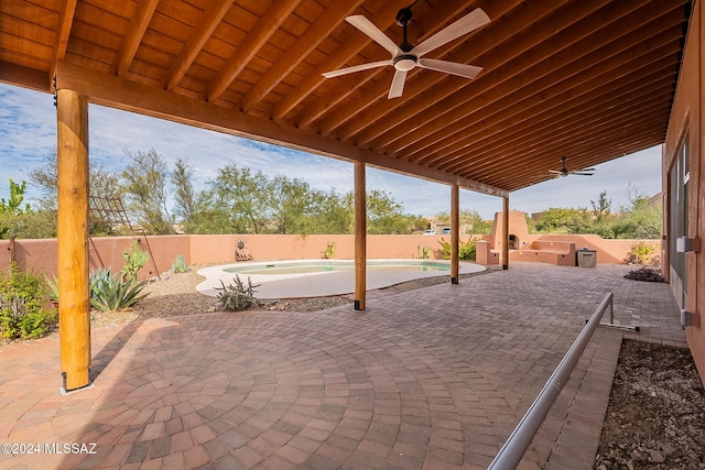 view of patio with a fenced in pool and ceiling fan